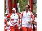 legenda-bulutangkis-indonesia-verawaty-wiharjo-saat-membawa-obor-asian-games.jpg