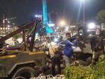 proses-evakuasi-mobil-toyota-innova-hitam-beropol-b-1981-kkn-yang-mengalami-kecelakaan-di-tugu-muda.jpg