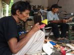 sugiyarto-sedang-mengecat-kerangka-baling-baling-untuk-mainan-kincir-angin_20181014_151428.jpg