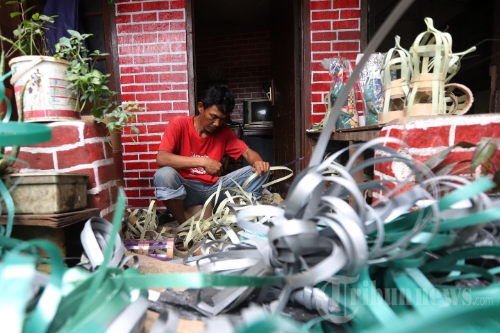 Pekerja saat menyelesaikan pembuatan miniatur ondel-ondel yang terbuat dari barang-barang bekas di Kawasan Banjir Kanal Timur, Jakarta Timur, Selasa (19/3/2019). Dalam sehari dirinya dapat membuat miniatur ondel-ondel sebanyak 50 hingga 100 buah dengan dibanderol seharga Rp 30.000 hingga Rp 50.000 tergantung ukuran. Tribunnews/Jeprima