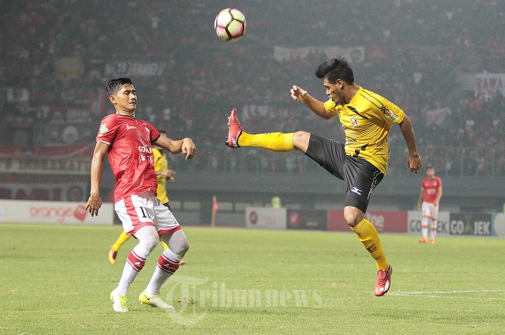 Rudi Widowo Hadang Laju Pemain Semen Padang