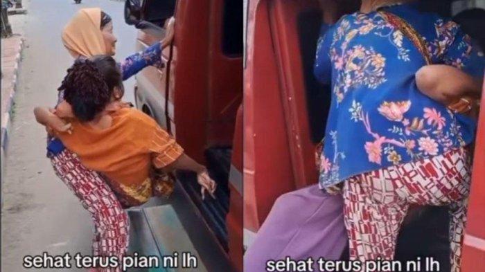 Terlihat ibu yang sudah tua berusaha sekuat tenaga menggendong anaknya