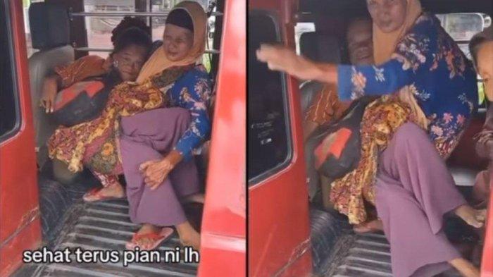 ibu berkerudung oranye ini terlihat kesulitan menggendong anaknya yang sudah besar untuk masuk ke dalam angkot