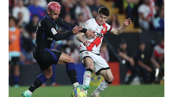 Penyerang Atletico Madrid asal Prancis Antoine Griezmann (kiri) berebut bola dengan bek Spanyol Rayo Vallecano Fran Garcia selama pertandingan sepak bola liga Spanyol antara Rayo Vallecano de Madrid dan Club Atletico de Madrid di stadion Vallecas di Madrid pada 9 April 2023.