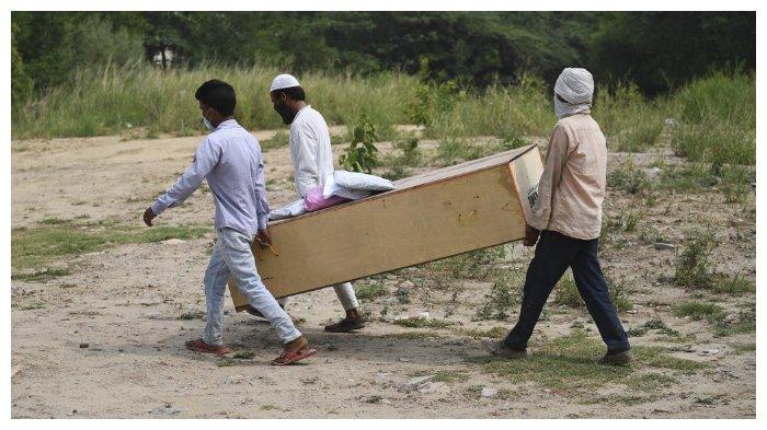 Tiga pria menggotong peti jenazah anggota keluarganya yang meninggal karena terinfeksi virus corona, New Delhi (6/7/2020). 