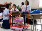 siswi-berusia-10-tahun-membawa-bayi-yang-merupakan-adiknya-ke-sekolah.jpg